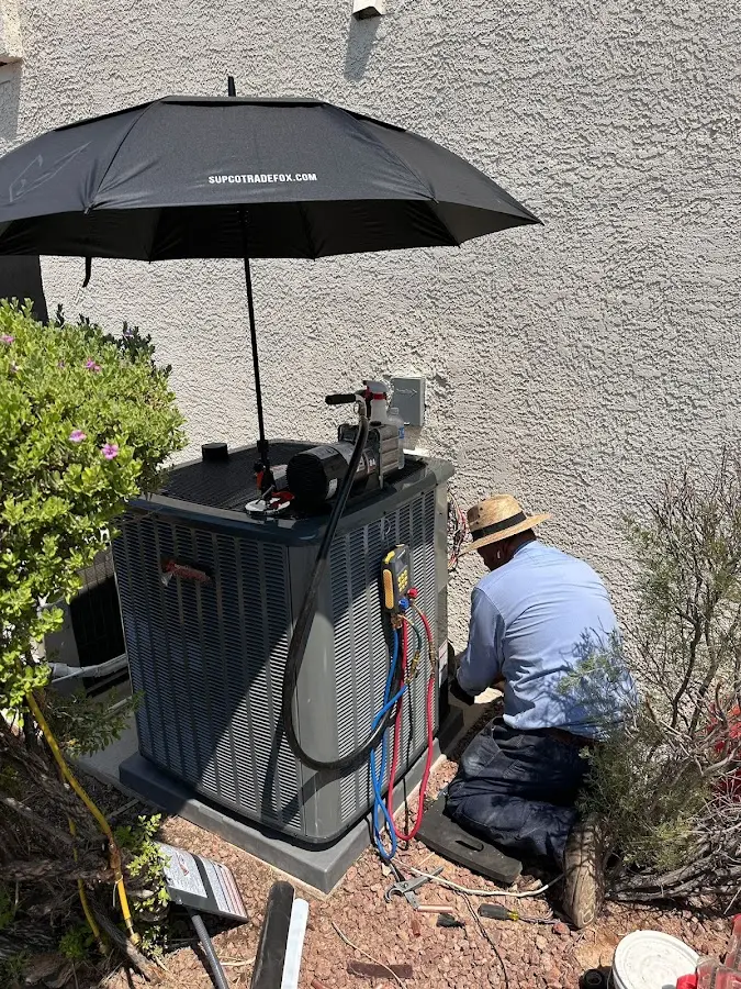 HVAC technician performing outdoor AC maintenance in Zimmerman